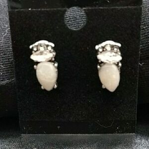 Silver tone earrings with a white stone